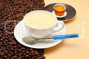 White cup of coffee and coffee beans