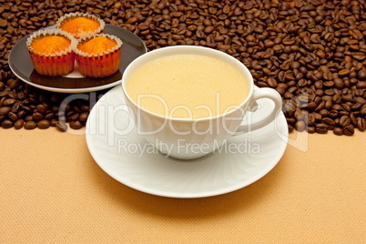 White cup of coffee and coffee beans