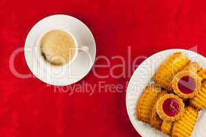 Coffee and cookies on a red background