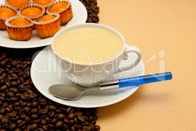 White cup of coffee and coffee beans