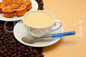 White cup of coffee and coffee beans