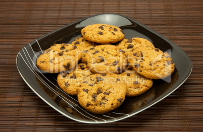 plate of cookies on dark brown background