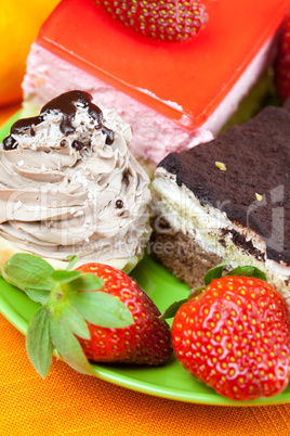 cake and strawberries lying on the orange fabric