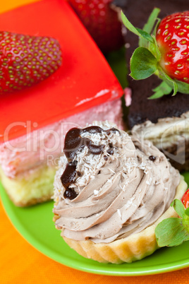 cake and strawberries lying on the orange fabric