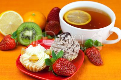 lemon,lemon tea,mandarin,kiwi,cake and strawberries lying on the