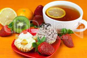 lemon,lemon tea,mandarin,kiwi,cake and strawberries lying on the