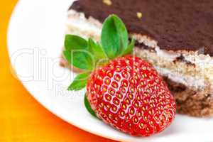 cake and strawberries lying on the orange fabric