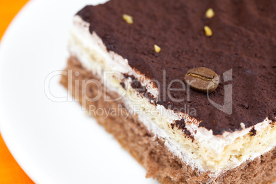 cake at the plate lying on an orange cloth