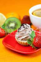 lemon tea ,lemon,mandarin.kiwi,cake and strawberries lying on th
