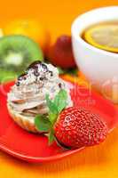 lemon tea ,lemon,mandarin.kiwi,cake and strawberries lying on th