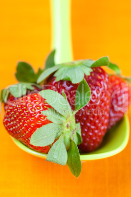 strawberries in a spoon of the orange fabric