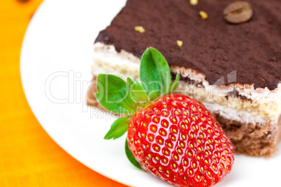 cake and strawberries lying on the orange fabric