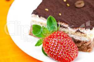 cake and strawberries lying on the orange fabric