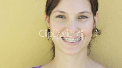 Beautiful happy young woman with dental braces