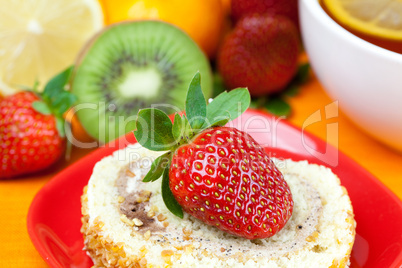 lemon,lemon tea,mandarin,kiwi,cake and strawberries lying on the