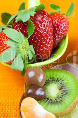 Strawberries, kiwi, mandarin orange, lemon and chocolate candy i