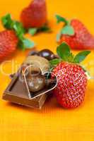 chocolate bars, strawberry, heart and the candy on the orange fa