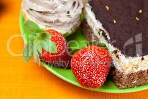 cake and strawberries lying on the orange fabric