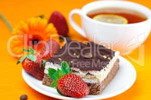 gerbera, lemon tea, cake and strawberries lying on the orange fa