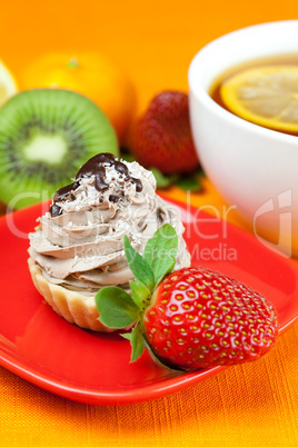 lemon tea ,lemon,mandarin.kiwi,cake and strawberries lying on th