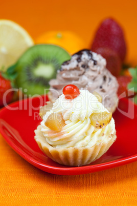 lemon,mandarin,kiwi,cake and strawberries lying on the orange fa