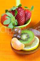 Strawberries, kiwi, mandarin orange, lemon and chocolate candy i