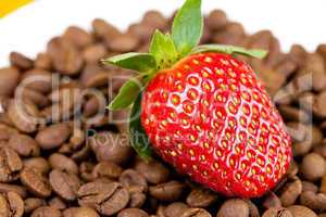 strawberries lying on a background of coffee beans