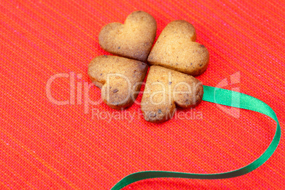 cookie  in the form of an Irish clover and green and green  on a