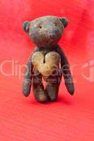 teddy bear  handmade and cookie  in the form of heart on a red b