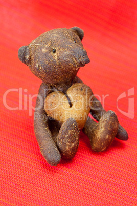 teddy bear  handmade and cookie  in the form of heart on a red b