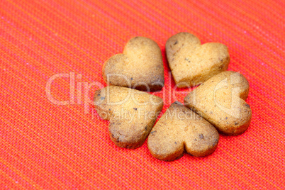 cookie  in the form of heart  in a plate  on a red background