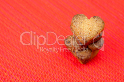 cookie  in the form of heart  in a plate  on a red background
