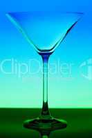 conceptually illuminated martini glass on gradient background