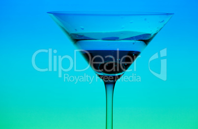 conceptually illuminated martini glass on gradient background