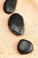 a black spa stones  on the towel
