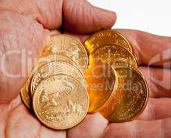 Hand holding stack of gold coins