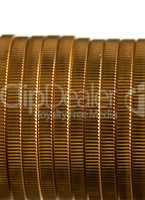 Edge view of stack of golden coins