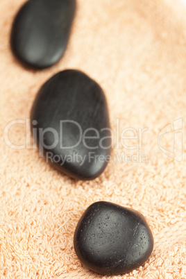 a black spa stones  on the towel