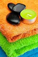 background of the three multi colored bath towels, spa black sto