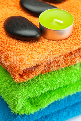 background of the three multi colored bath towels, spa black sto