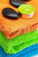 background of the three multi colored bath towels, spa black sto