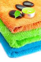 background of the three multi-colored bath towels, black spa sto