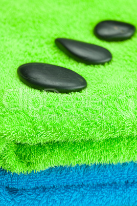 black spa stones lying on the towel