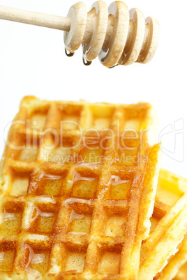 delicious Belgian waffles and stick to honey isolated on white