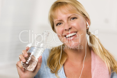 Pretty Blonde Woman with Towel Drinking From Water Bottle