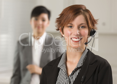Pretty Red Haired Businesswoman with Headset in Office