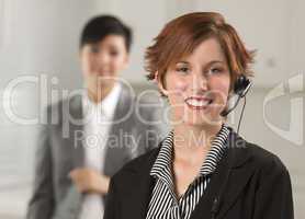 Pretty Red Haired Businesswoman with Headset in Office