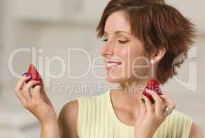 Pretty Red Haired Woman Holding Strawberry