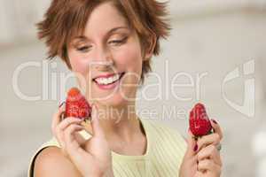 Pretty Red Haired Woman Holding Strawberry