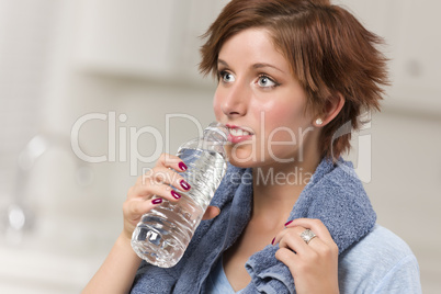 Pretty Red Haired Woman with Towel Drinking From Water Bottle